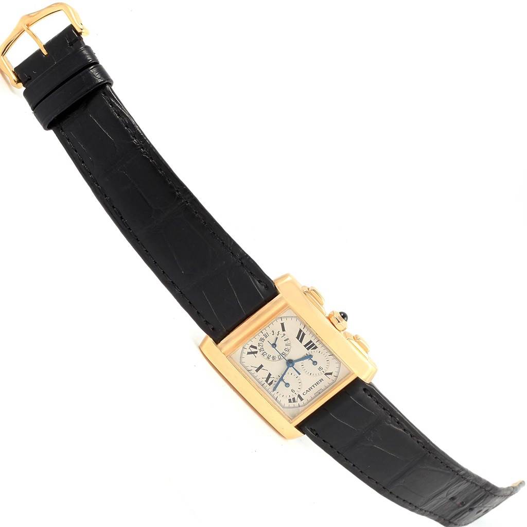 The Cartier Tank Française watch is shown from a top-down angle, highlighting the face, dial, case, and strap.