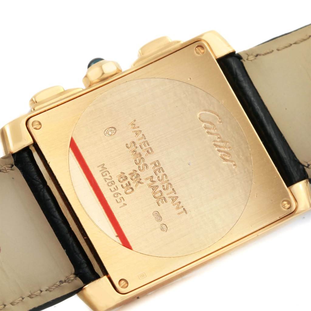 The image shows the back case of a Cartier Tank Française watch, highlighting its inscriptions and strap attachment.