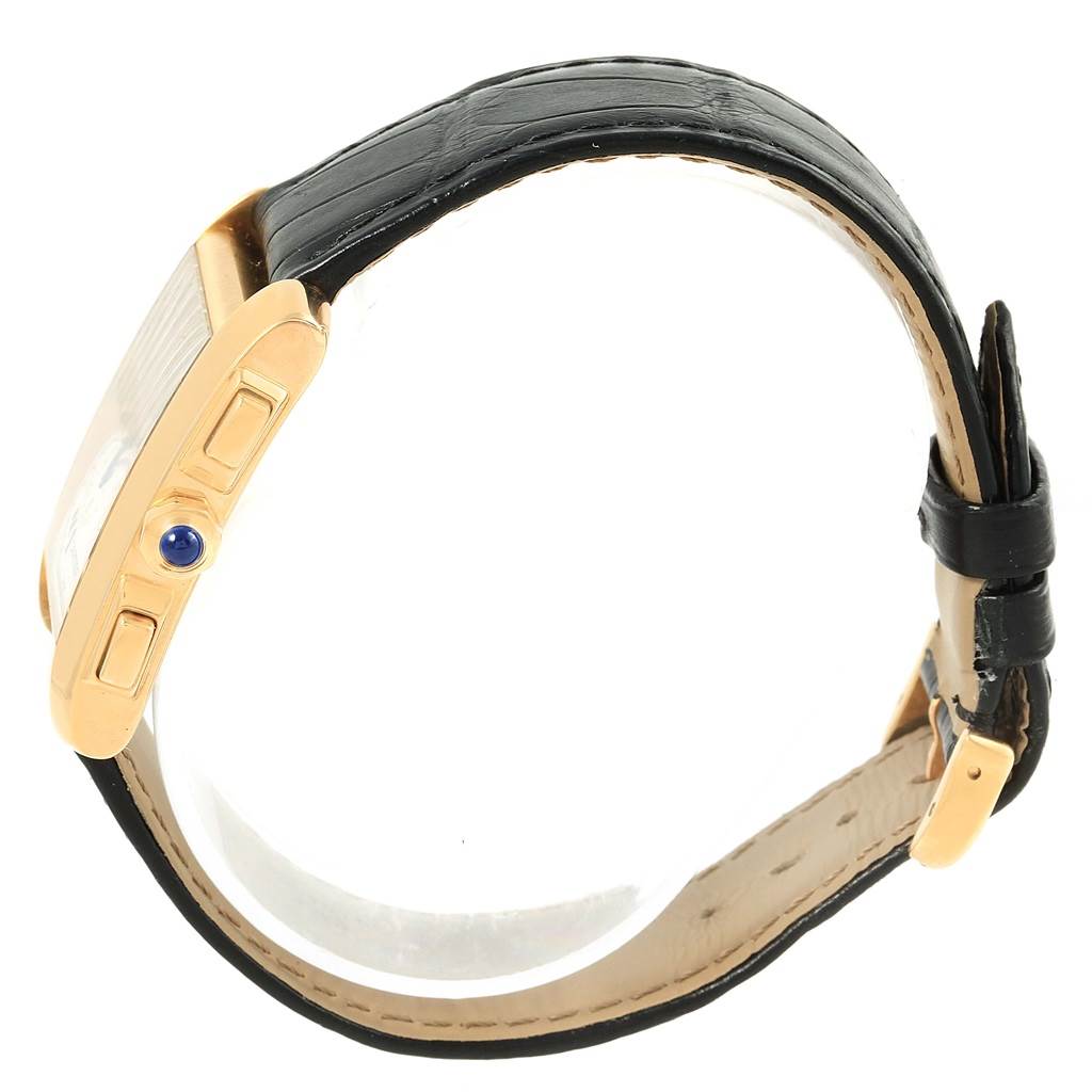 The image shows a side view of the Cartier Tank Francaise W5000556 Men's Yellow Gold Silver Dial W5000556 Men's Yellow Gold Silver Dial watch, highlighting its gold case, crown with blue cabochon, and black leather strap.