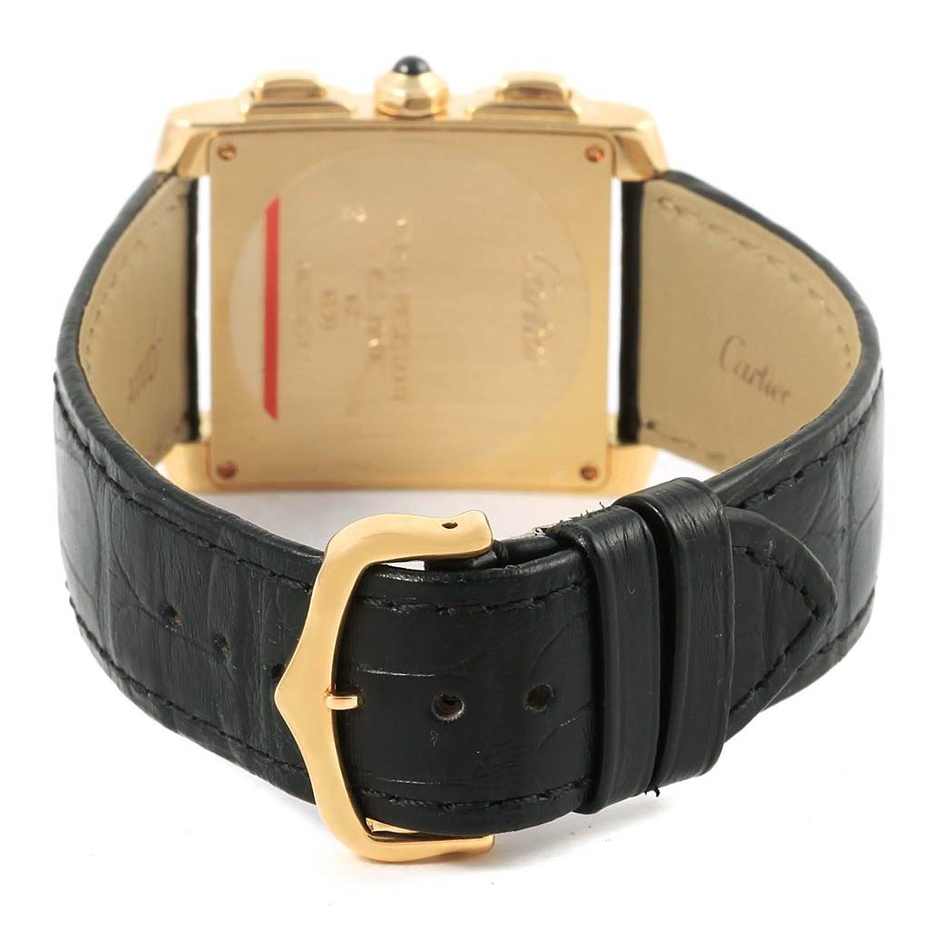 The image shows the back of a Cartier Tank Francaise W5000556 Men's Yellow Gold Silver Dial W5000556 Men's Yellow Gold Silver Dial watch with a black leather strap and a gold buckle.