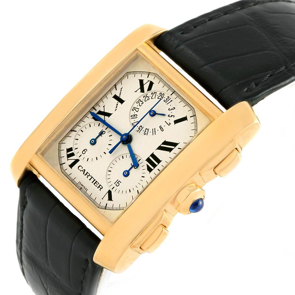 The image shows a Cartier Tank Francaise W5000556 Men's Yellow Gold Silver Dial W5000556 Men's Yellow Gold Silver Dial watch at an angled view, highlighting its dial, blue hands, black leather strap, and gold casing.