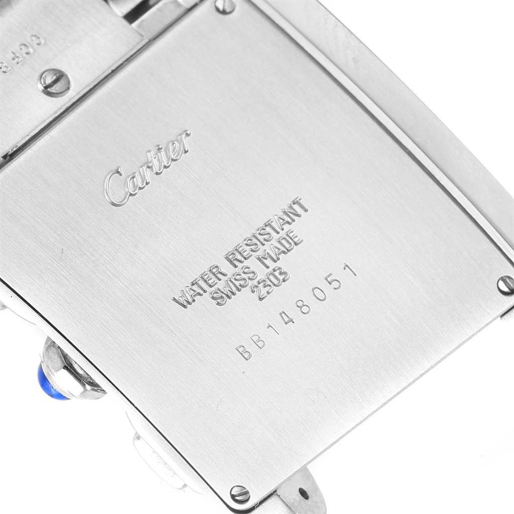 This image shows the engraved case back of a Cartier Tank Française watch, highlighting model details and serial number.