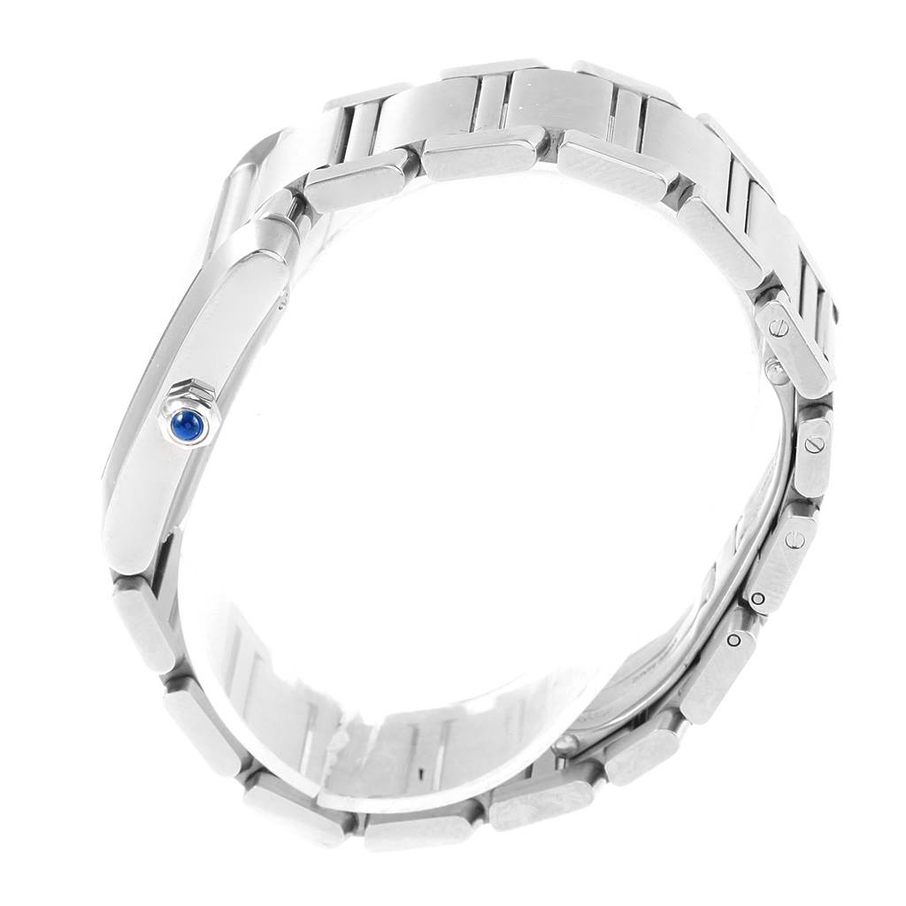 The image shows a side view of the Cartier Tank Française, highlighting the bracelet and the crown with a blue cabochon.