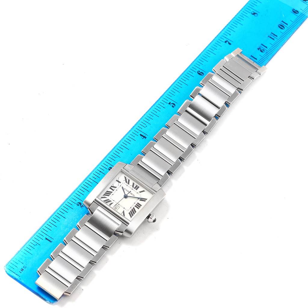 The Cartier Tank Francaise W51002Q3 Stainless Steel Silver Dial W51002Q3 Stainless Steel Silver Dial watch is shown from a top-down angle, displaying the face, bracelet, and a ruler for size reference.