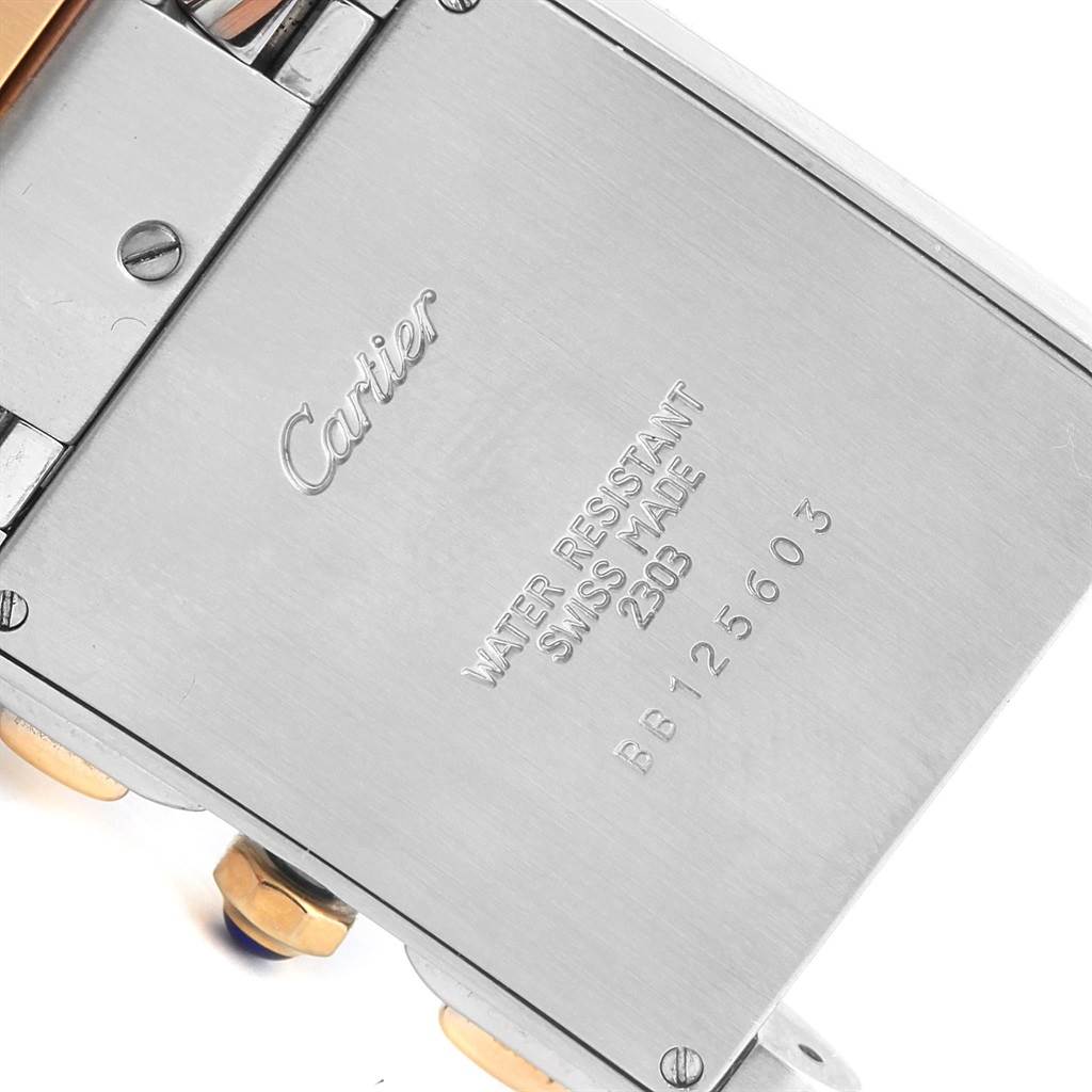 This photo captures the back case of the Cartier Tank Francaise W51004Q4 Men's Steel and Gold (two tone) Silver Dial W51004Q4 Men's Steel and Gold (two tone) Silver Dial model, showcasing brand markings and serial information.