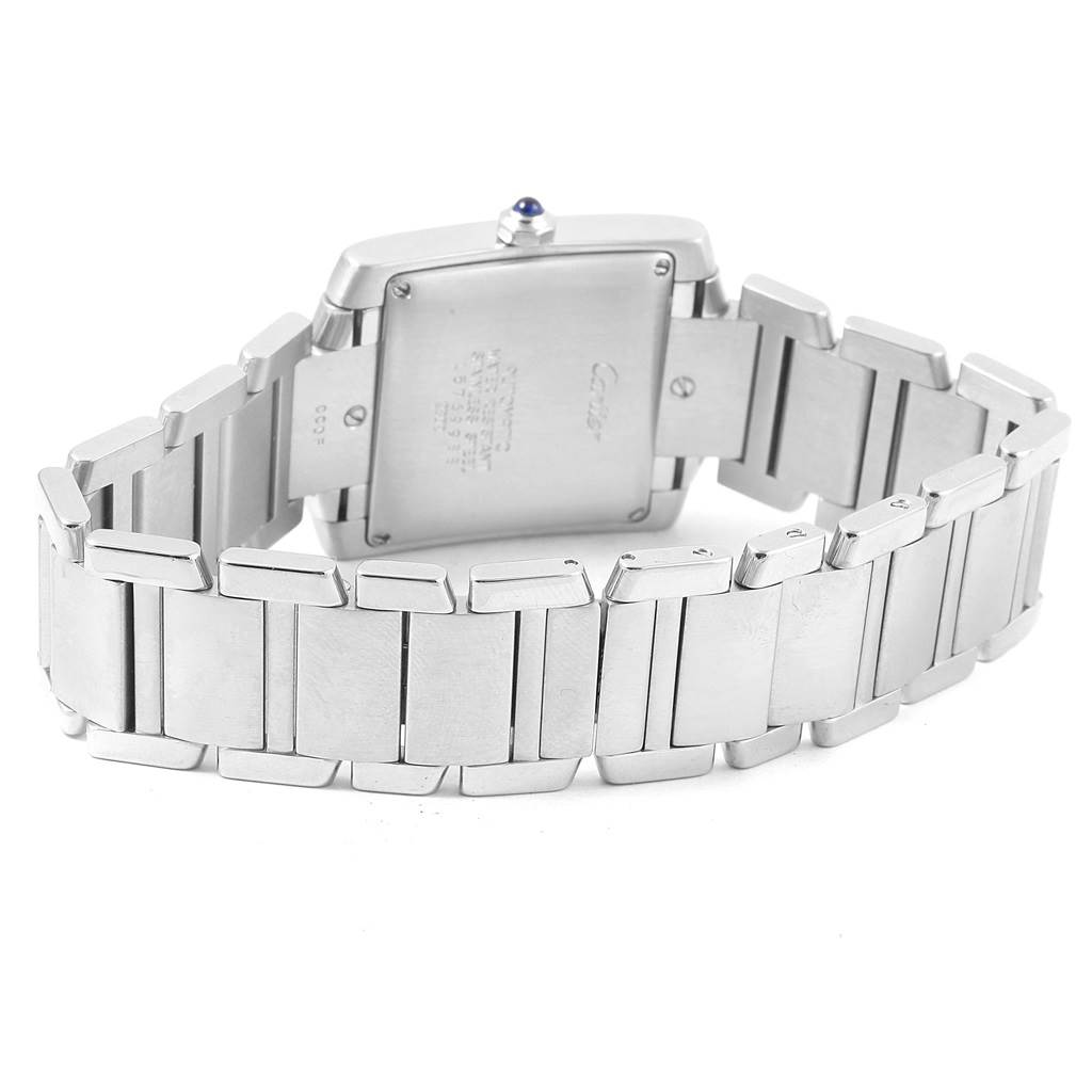 The image shows a rear view of a Cartier Tank Française watch, highlighting its case back and metal bracelet.
