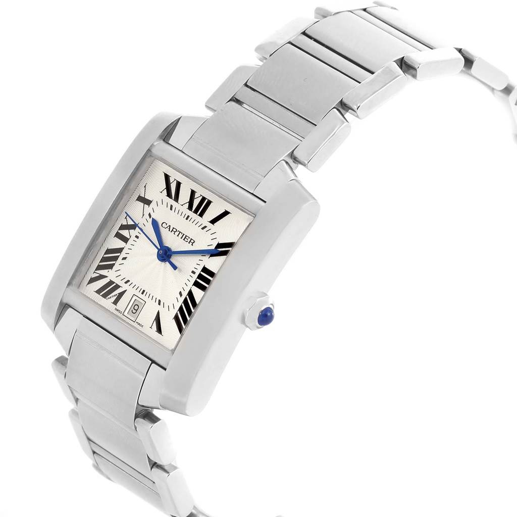 The Tank Francaise by Cartier is shown from an angled view, displaying the face, bracelet, and crown with a blue cabochon.