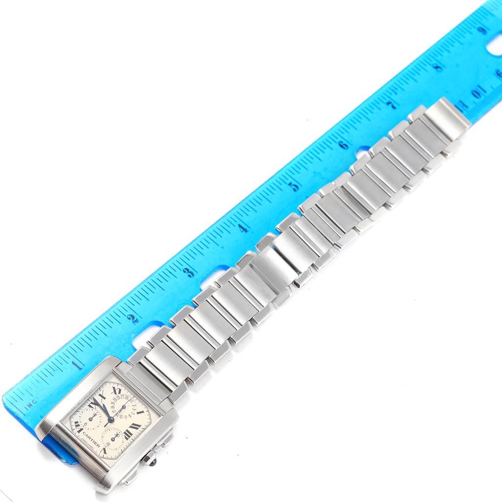 The image shows a Cartier Tank Francaise W51001Q3 Men
s Stainless Steel White Dial W51001Q3 Men
s Stainless Steel White Dial watch laid flat next to a blue ruler, displaying the face and metal bracelet.