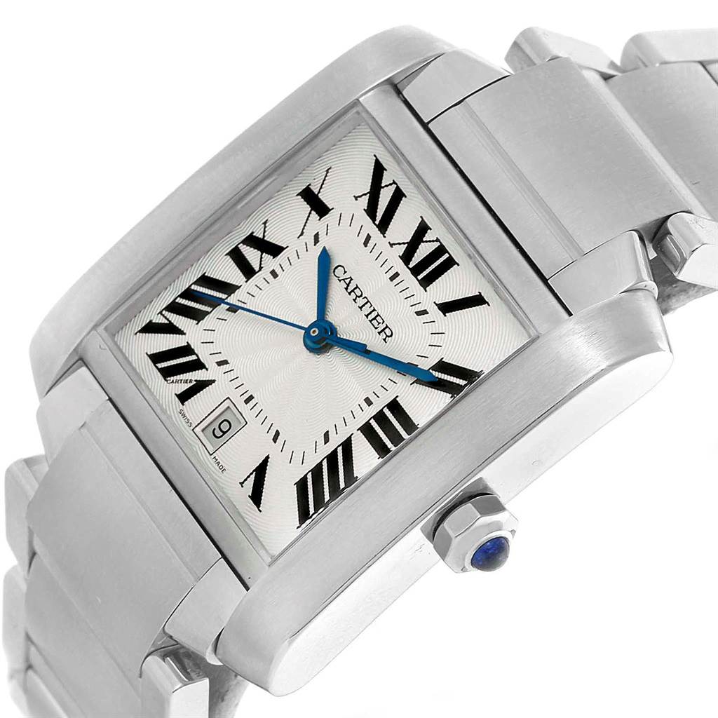 The Cartier Tank Francaise W51002Q3 Stainless Steel Silver Dial W51002Q3 Stainless Steel Silver Dial watch is shown at an angle, highlighting its face, bracelet, blue hands, and crown with a blue gem.