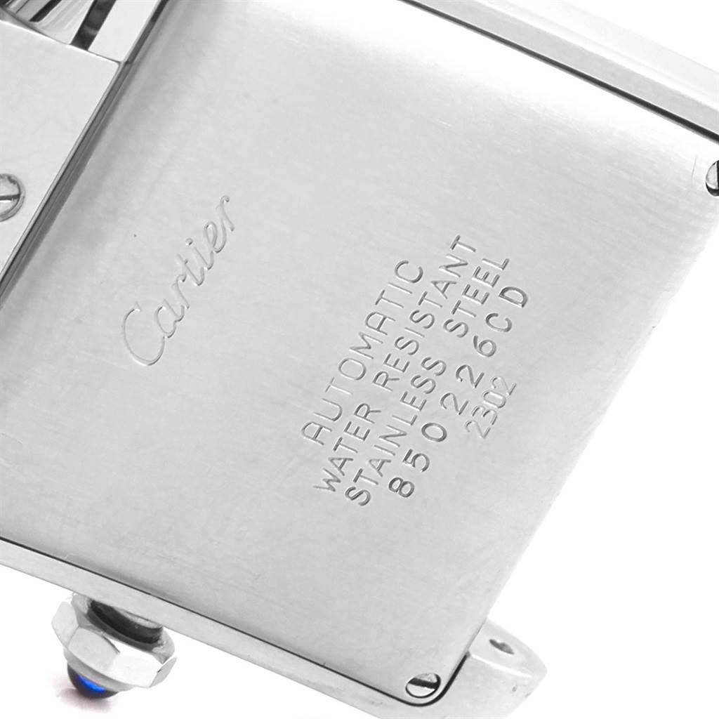 The image shows a close-up of the back case of a Cartier Tank Française watch, highlighting its engraving details.