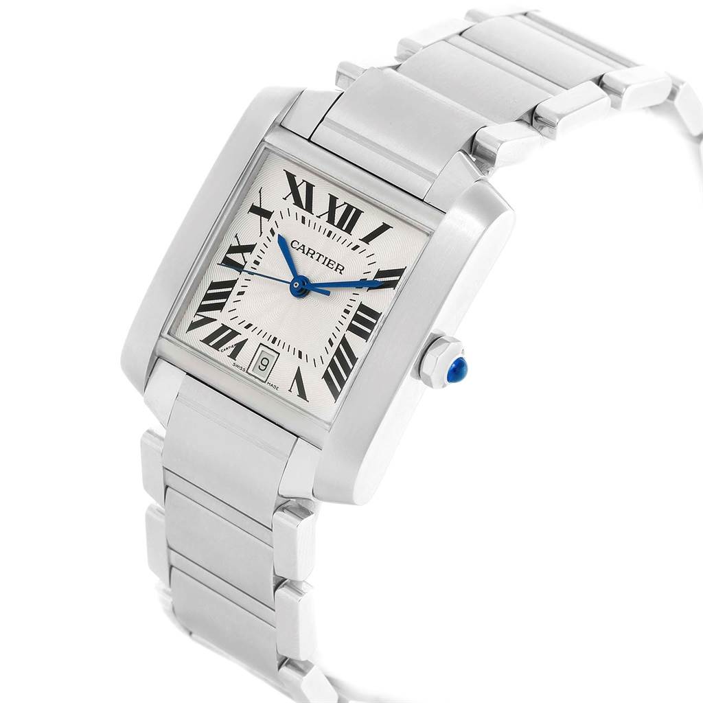 The Cartier Tank Française watch is shown at an angle highlighting its rectangular face, bracelet, and crown with a blue gem.