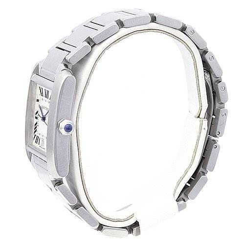 The image shows a side view of the Cartier Tank Française watch, highlighting its metal bracelet, rectangular dial, and blue cabochon crown.