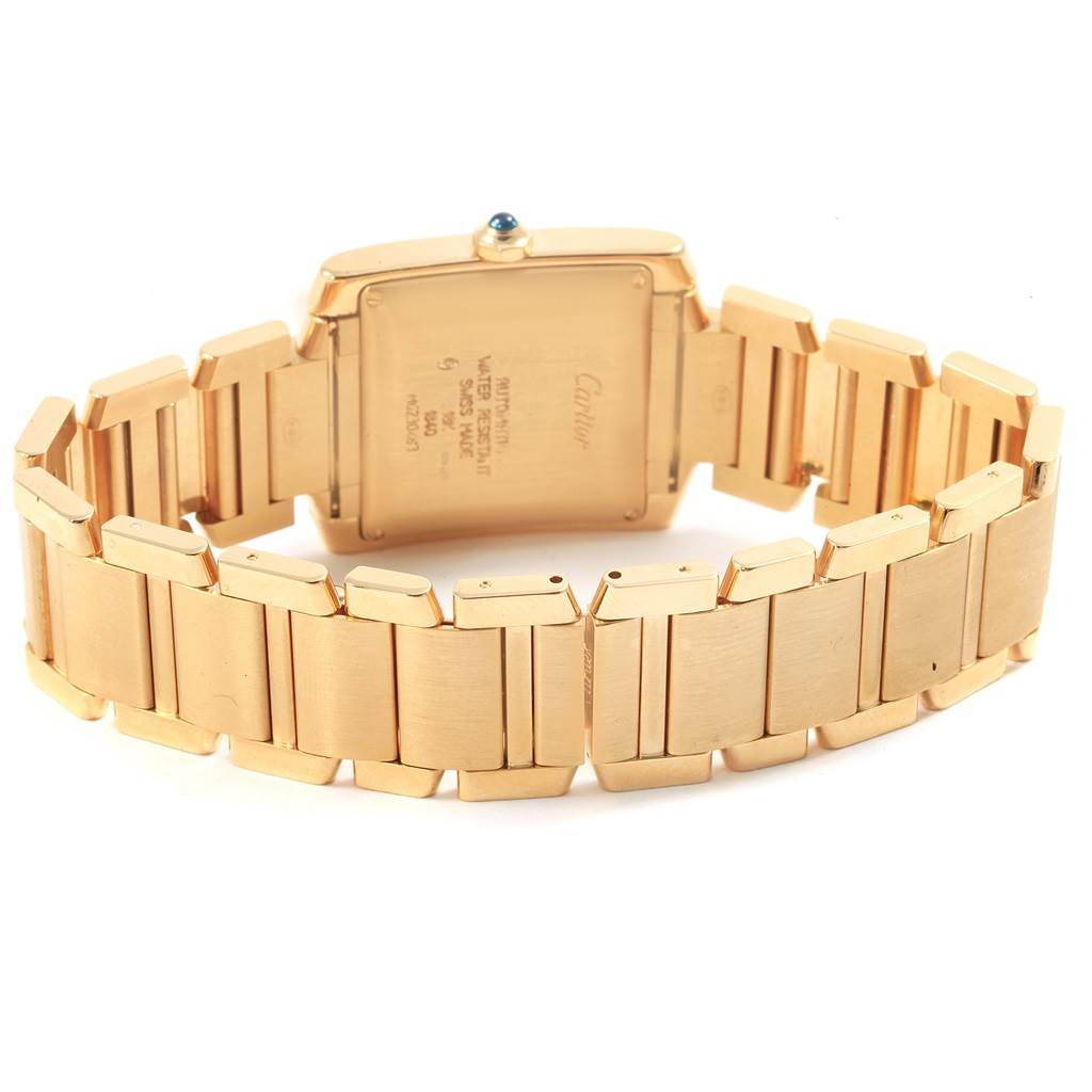 The image shows the back and bracelet of a Cartier Tank Française watch, highlighting the gold links and case back.