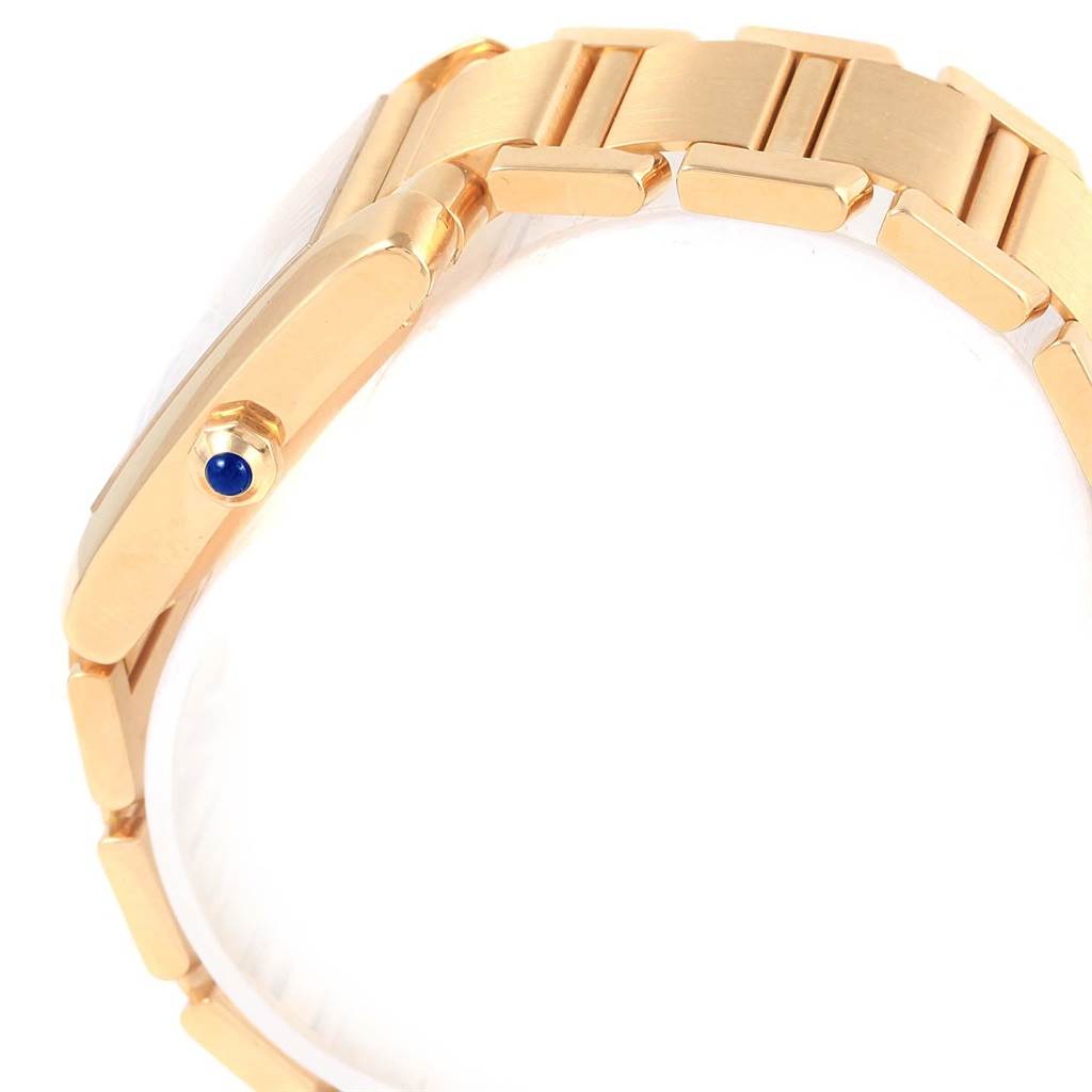 The image shows a side profile of a Cartier Tank Francaise W50001R2 Yellow Gold Silver Dial W50001R2 Yellow Gold Silver Dial watch, highlighting its gold bracelet and crown with a blue cabochon.