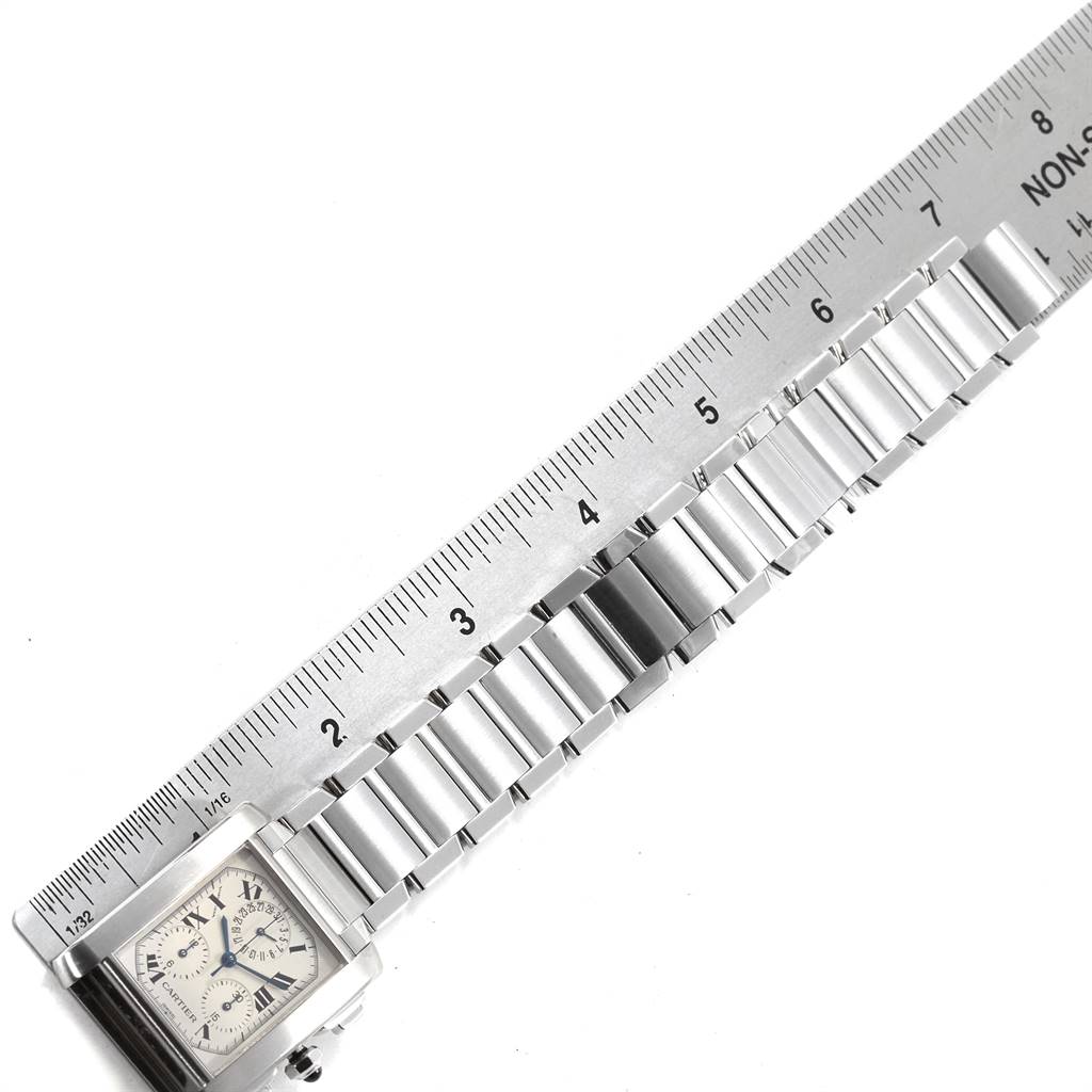 The image shows the face and bracelet of a Cartier Tank Française watch, with a ruler measuring its length.