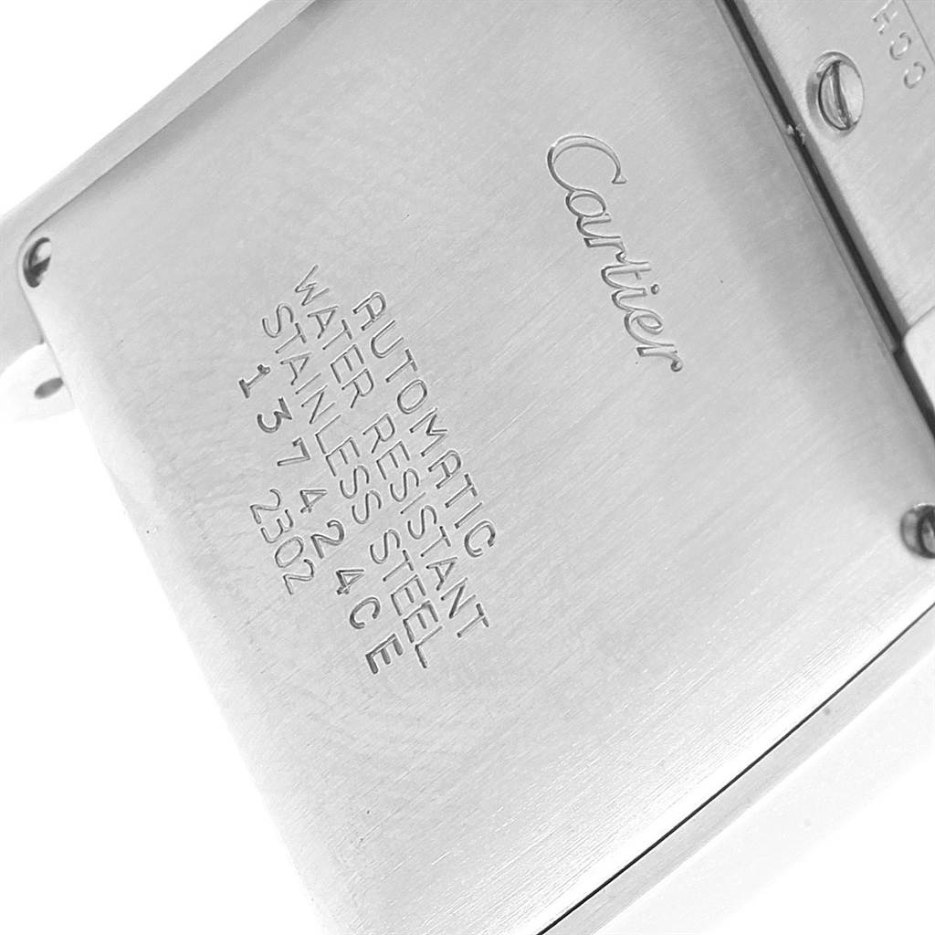 This image shows the back case of a Cartier Tank Française watch with engraved details about its features.