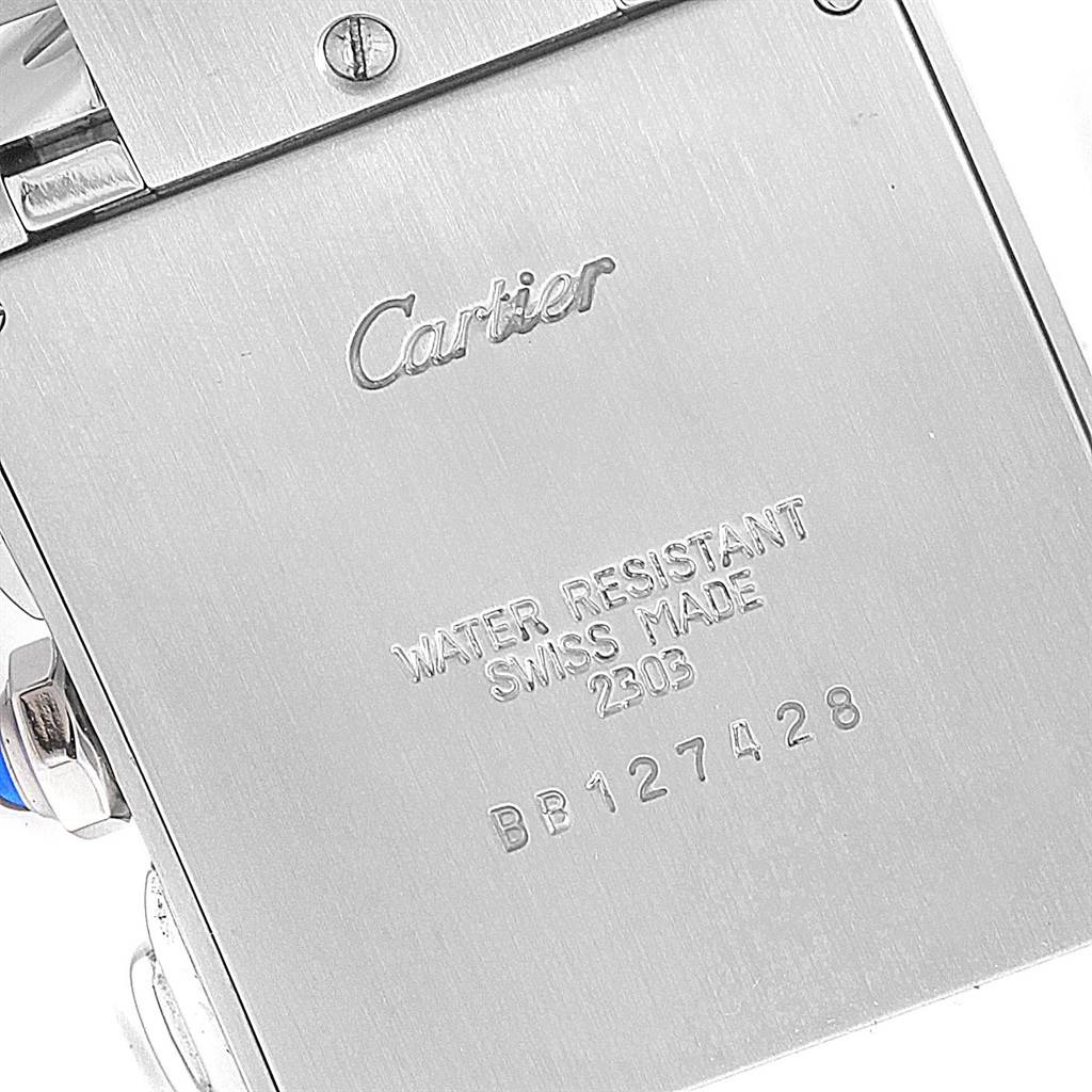 The image shows the backside of a Tank Francaise watch by Cartier, highlighting the inscriptions on its case.