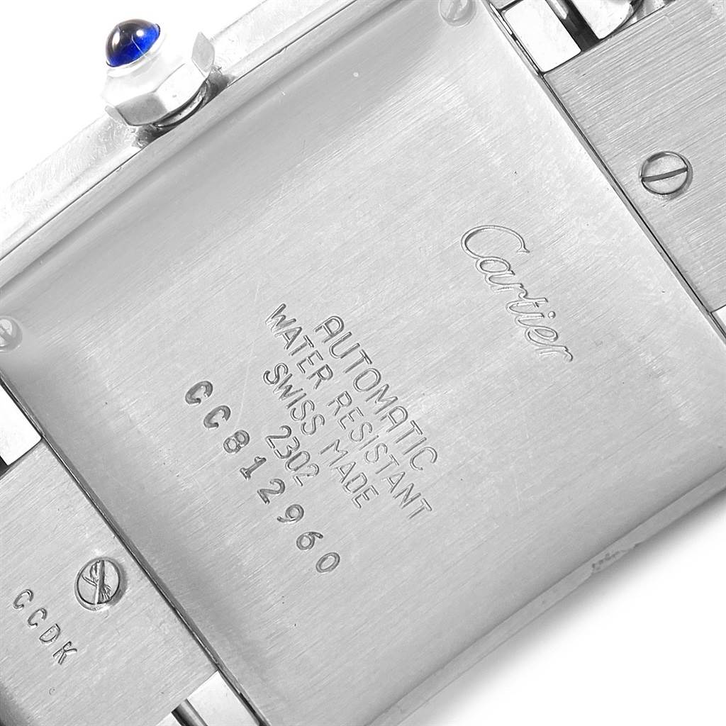 This image shows the back case of the Cartier Tank Francaise W51002Q3 Stainless Steel Silver Dial W51002Q3 Stainless Steel Silver Dial watch, highlighting its inscriptions and crown with a blue cabochon.
