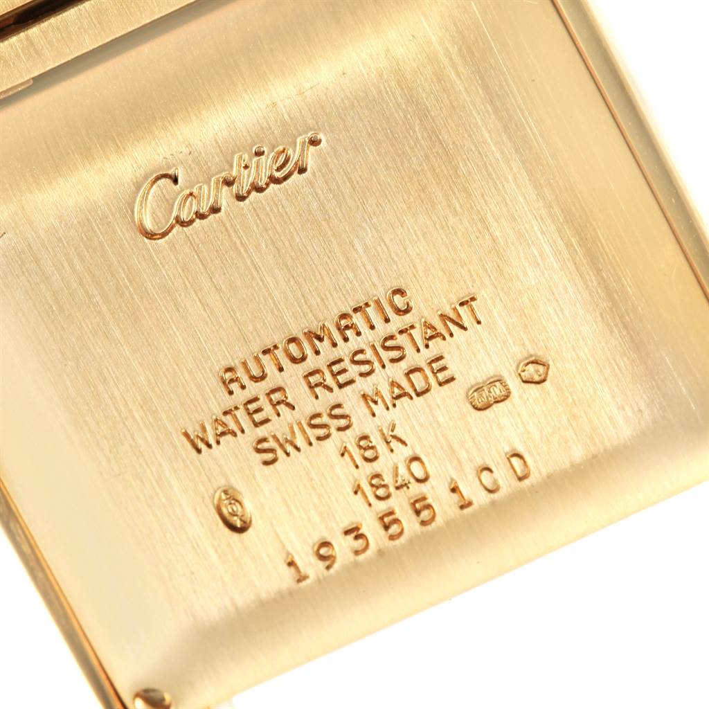The image shows the back case of a Tank Française watch by Cartier, displaying its engravings and specifications.