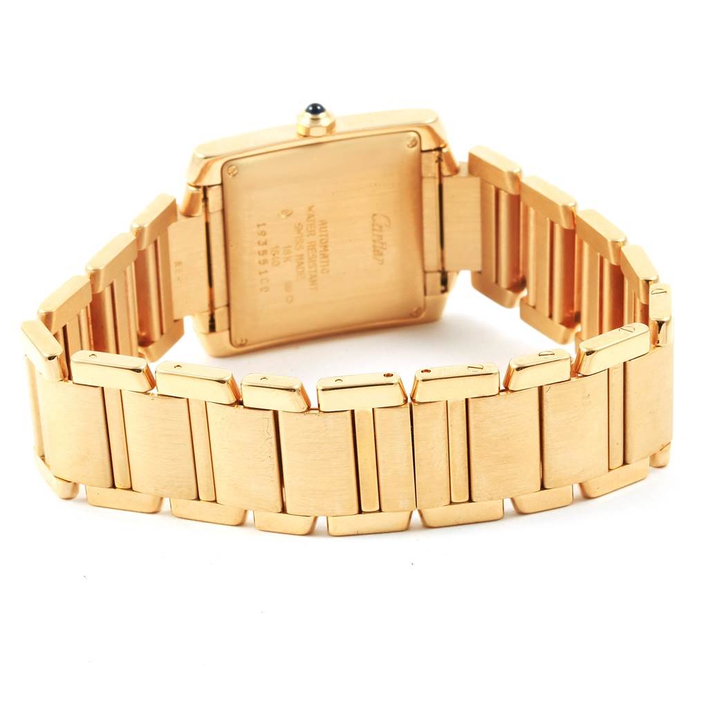 This image shows the back and part of the bracelet of a Cartier Tank Francaise W50001R2 Yellow Gold Silver Dial W50001R2 Yellow Gold Silver Dial watch, emphasizing the gold casing and link design.