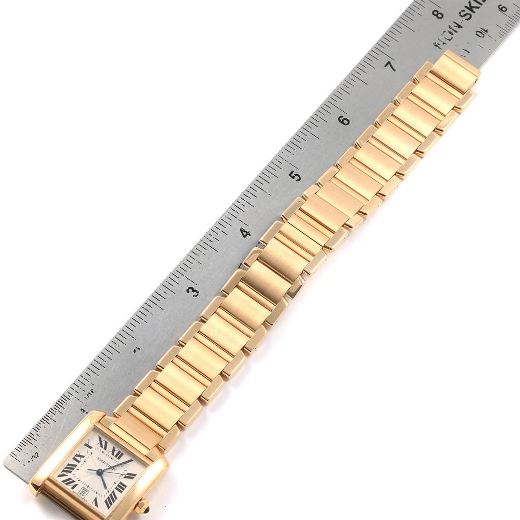 The Cartier Tank Francaise W50001R2 Yellow Gold Silver Dial W50001R2 Yellow Gold Silver Dial watch is shown from its face to the full length of its gold bracelet, measured against a ruler.
