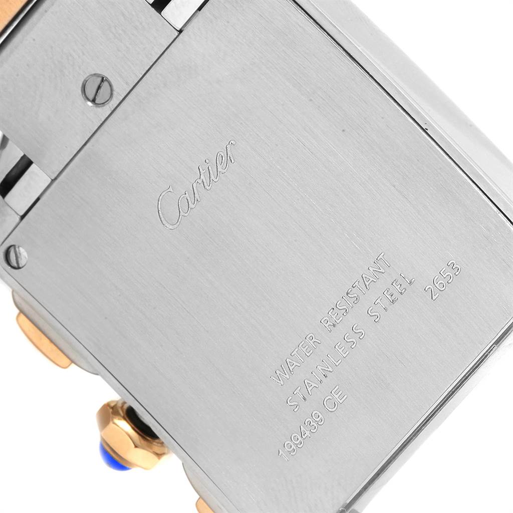 The image shows the back of a Cartier Tank Française watch, highlighting its stainless steel case and inscriptions.