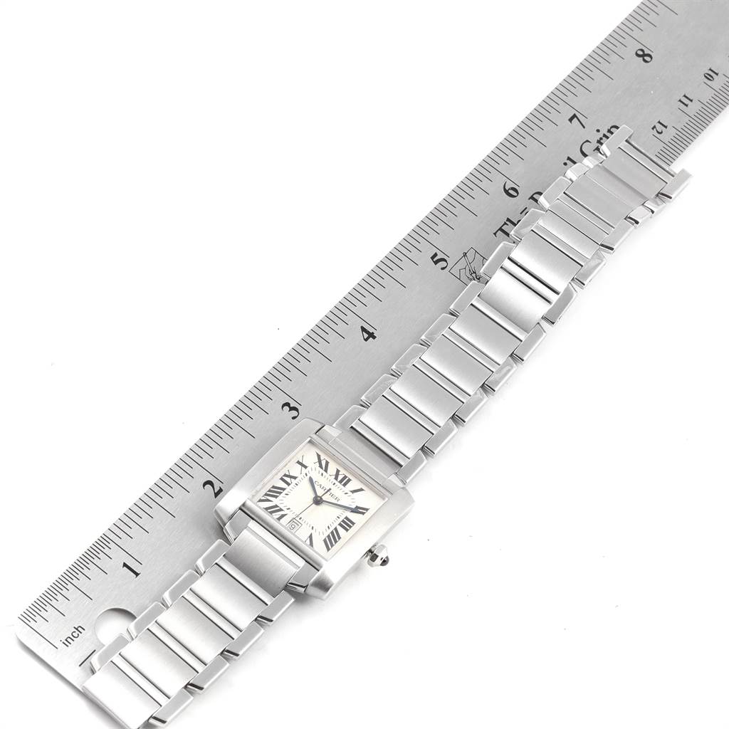 The Cartier Tank Francaise W51002Q3 Men's Stainless Steel Silver Dial W51002Q3 Men's Stainless Steel Silver Dial watch is shown from a top-down angle, lying flat next to a ruler.