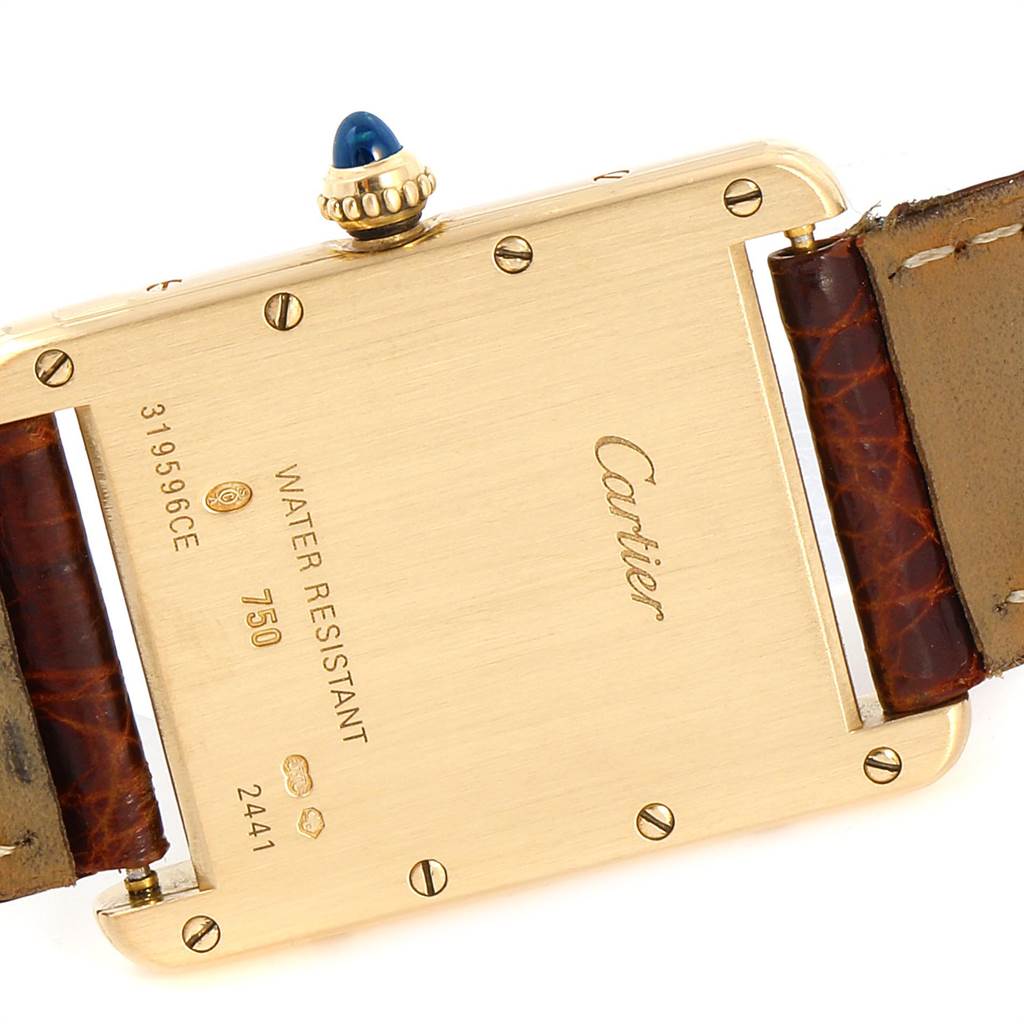 The image shows the back, crown, and part of the strap of a Cartier Tank Francaise W1529756 Men's Yellow Gold Silver Dial W1529756 Men's Yellow Gold Silver Dial watch.