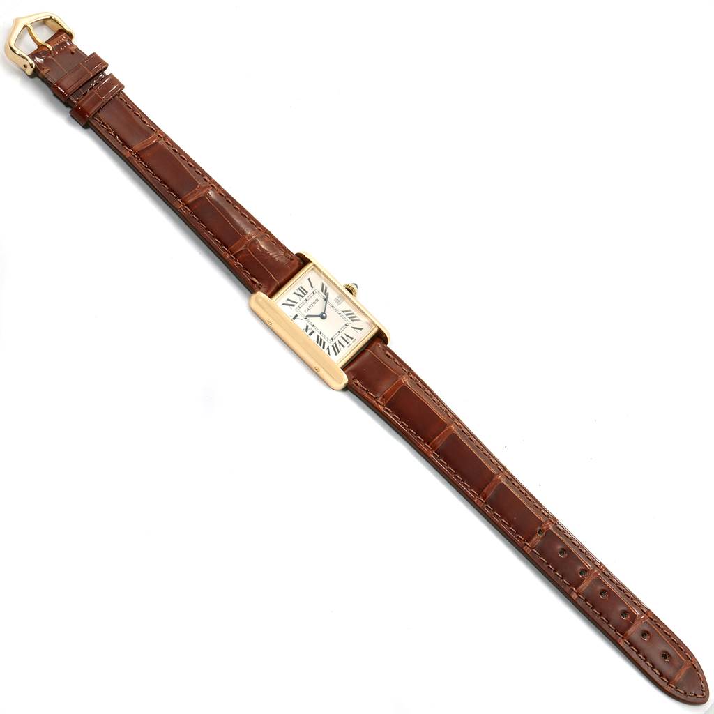 The Cartier Tank Francaise W1529756 Men's Yellow Gold Silver Dial W1529756 Men's Yellow Gold Silver Dial watch is shown from a top-down angle, showcasing its rectangular face and brown leather strap.