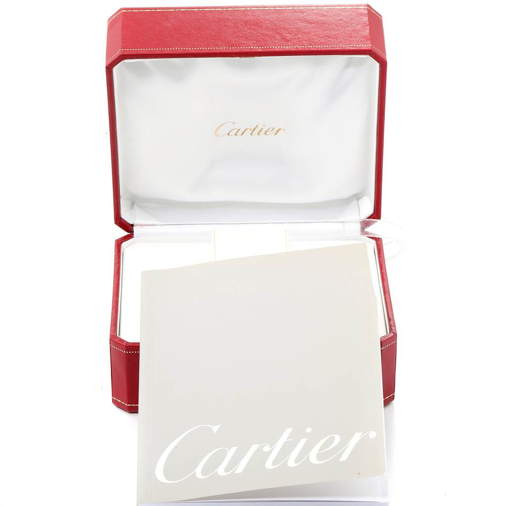 The image shows the open box and manual of a Cartier Tank Française watch.