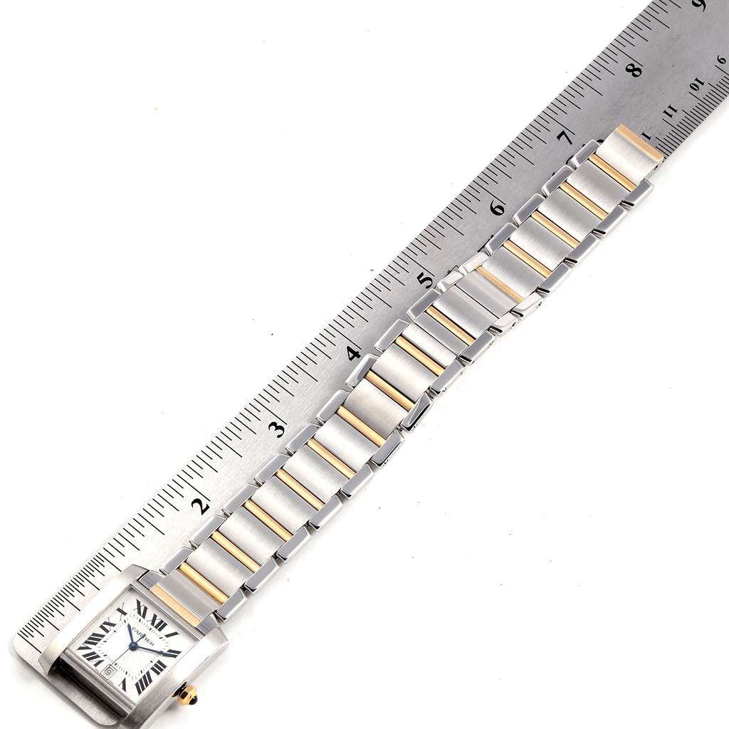 The Cartier Tank Francaise W51005Q4 Men's Steel and Gold (two tone) Silver Dial W51005Q4 Men's Steel and Gold (two tone) Silver Dial watch is shown from an overhead angle, displaying the watch face and bracelet alongside a ruler for scale.