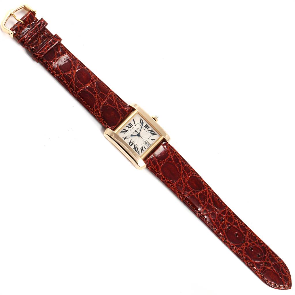 The image shows a top view of the Cartier Tank Francaise W5000156 Yellow Gold Silver Dial W5000156 Yellow Gold Silver Dial watch with a brown leather strap and rectangular face.