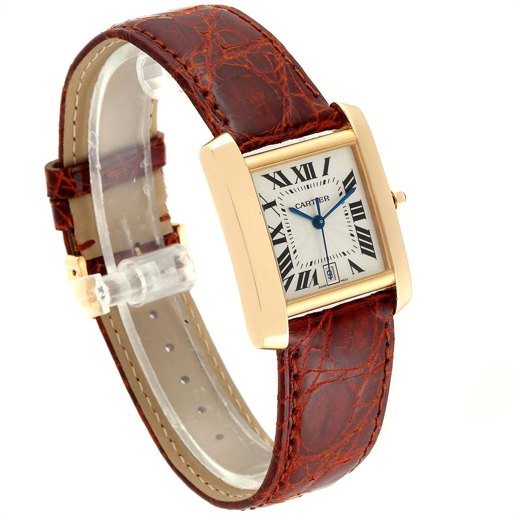 This image shows a Cartier Tank Francaise W5000156 Yellow Gold Silver Dial W5000156 Yellow Gold Silver Dial watch at an angled view, highlighting its face, leather strap, and gold casing.