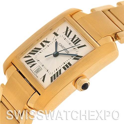 The image shows a close-up of a Cartier Tank Francaise W50001R2 Stainless Steel Silver Dial W50001R2 Stainless Steel Silver Dial watch, highlighting its gold case, Roman numeral dial, and bracelet.