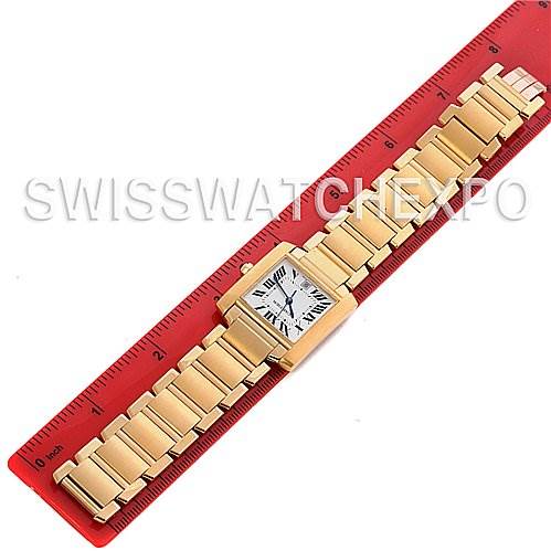 The Cartier Tank Francaise W50001R2 Stainless Steel Silver Dial W50001R2 Stainless Steel Silver Dial watch is shown from an overhead view, laid flat next to a red ruler.