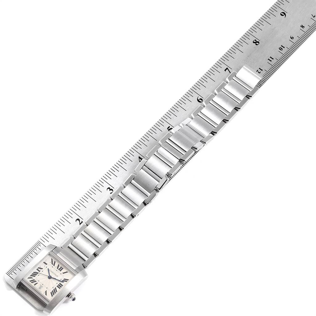 The Cartier Tank Francaise W51002Q3 Stainless Steel Silver Dial W51002Q3 Stainless Steel Silver Dial watch is shown from an angled top view, with the bracelet and case next to a ruler for measurement.