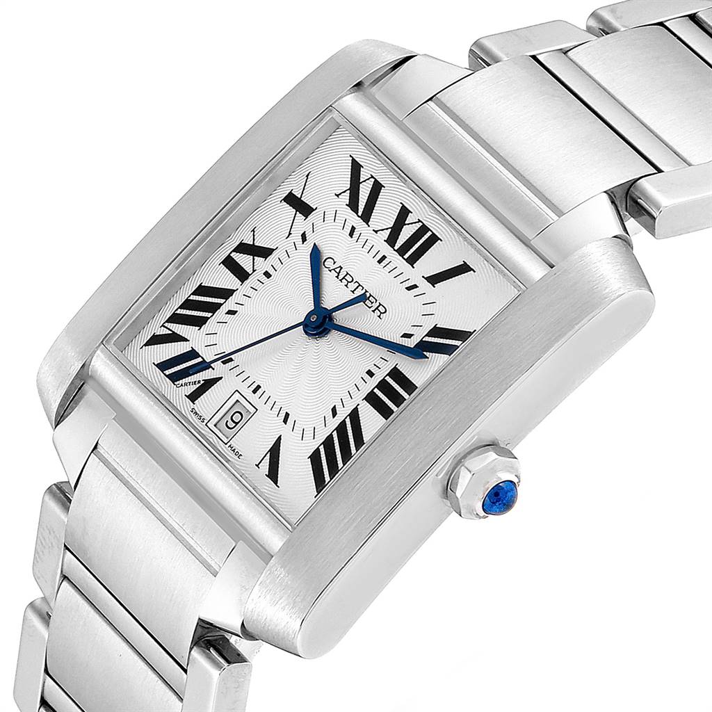 This image shows a Cartier Tank Française watch at an oblique angle, highlighting its rectangular face, bracelet, and crown with a blue gem.