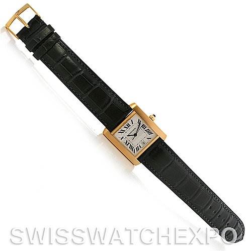 This image shows a Cartier Tank Française watch from a top-down angle, featuring a rectangular face and black leather strap.