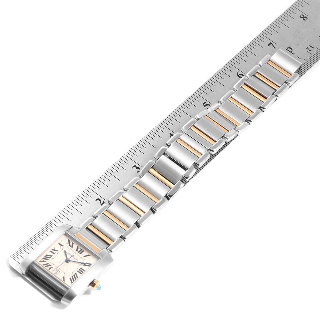 The image shows a Cartier Tank Francaise W51005Q4 Men's Steel and Gold (two tone) Silver Dial W51005Q4 Men's Steel and Gold (two tone) Silver Dial watch, displaying its face and two-tone metal bracelet against a ruler for scale.