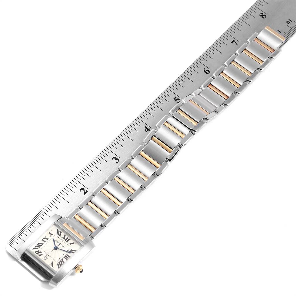 The image shows the face, bezel, and bracelet of a Cartier Tank Française watch, measured against a ruler.