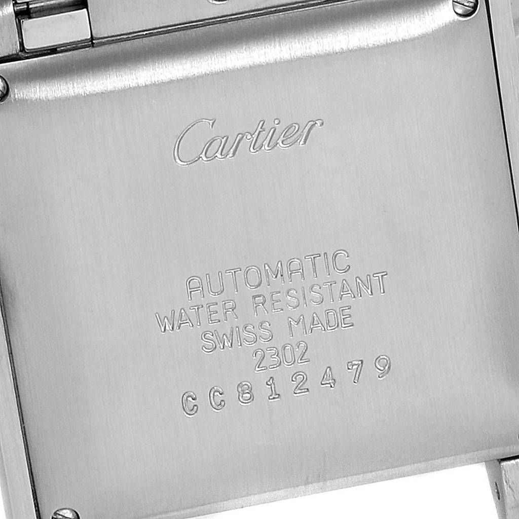 This image shows the back case of the Cartier Tank Française watch, highlighting the engraved details.