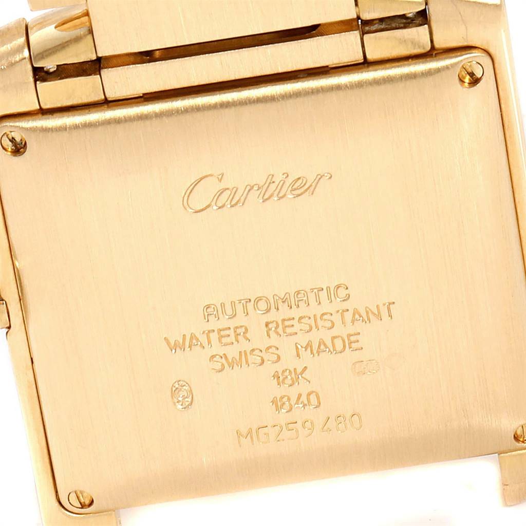 This image shows the back case of a Cartier Tank Française watch, highlighting its engravings and the clasp.