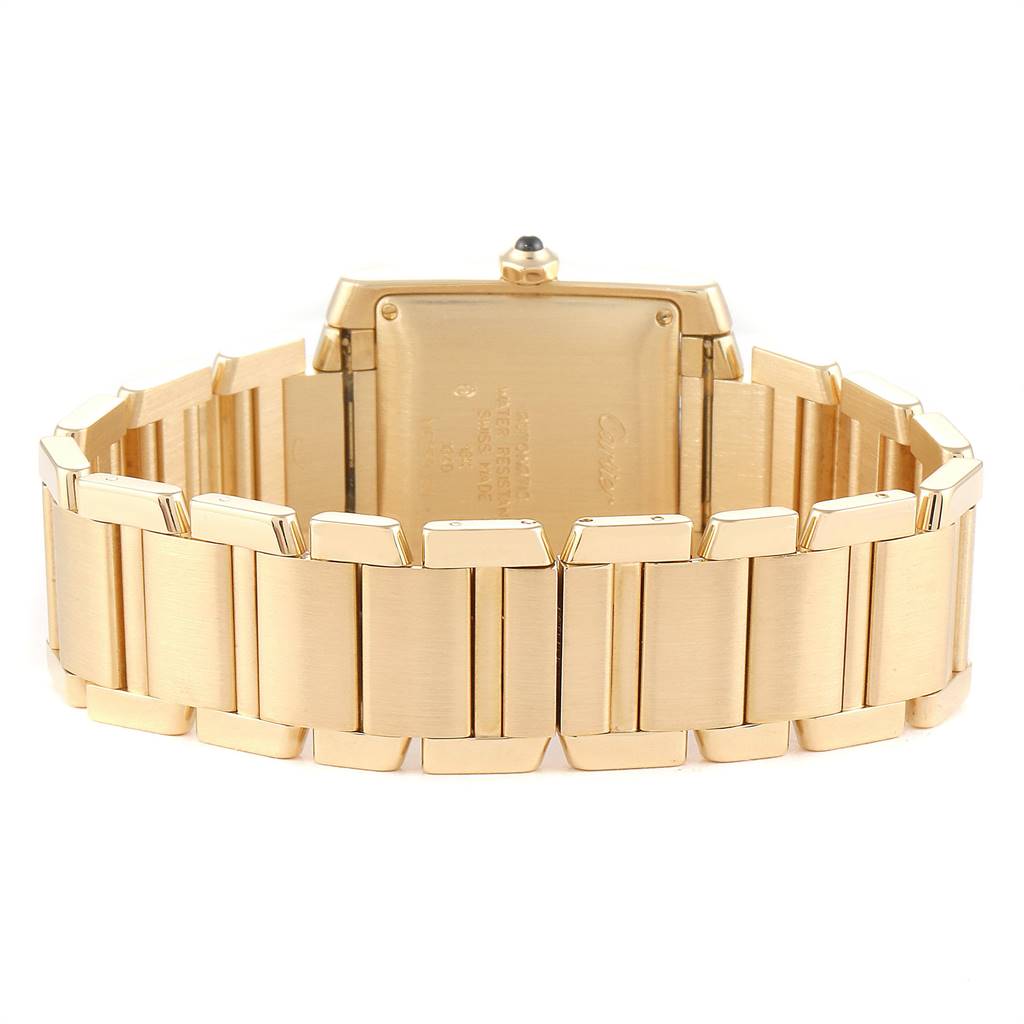 The image shows the back and the gold bracelet of the Cartier Tank Française watch.