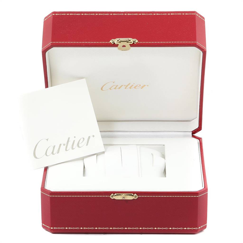 This image shows the open red box of a Cartier Tank Francaise W50001R2 Yellow Gold Silver Dial W50001R2 Yellow Gold Silver Dial watch, displaying its interior and a booklet.