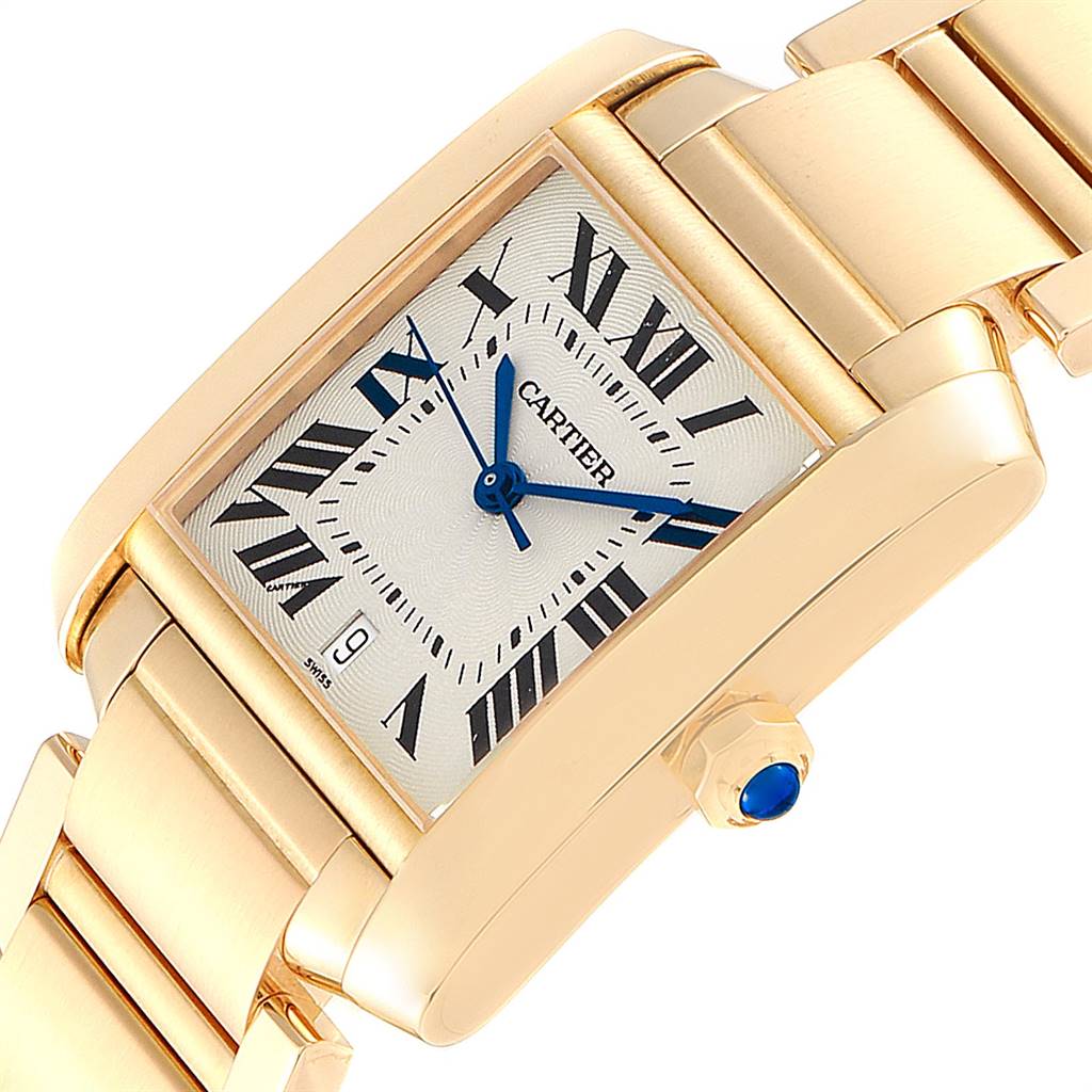 The image shows a close-up of a gold Cartier Tank Française watch, highlighting the face, crown, and part of the bracelet.
