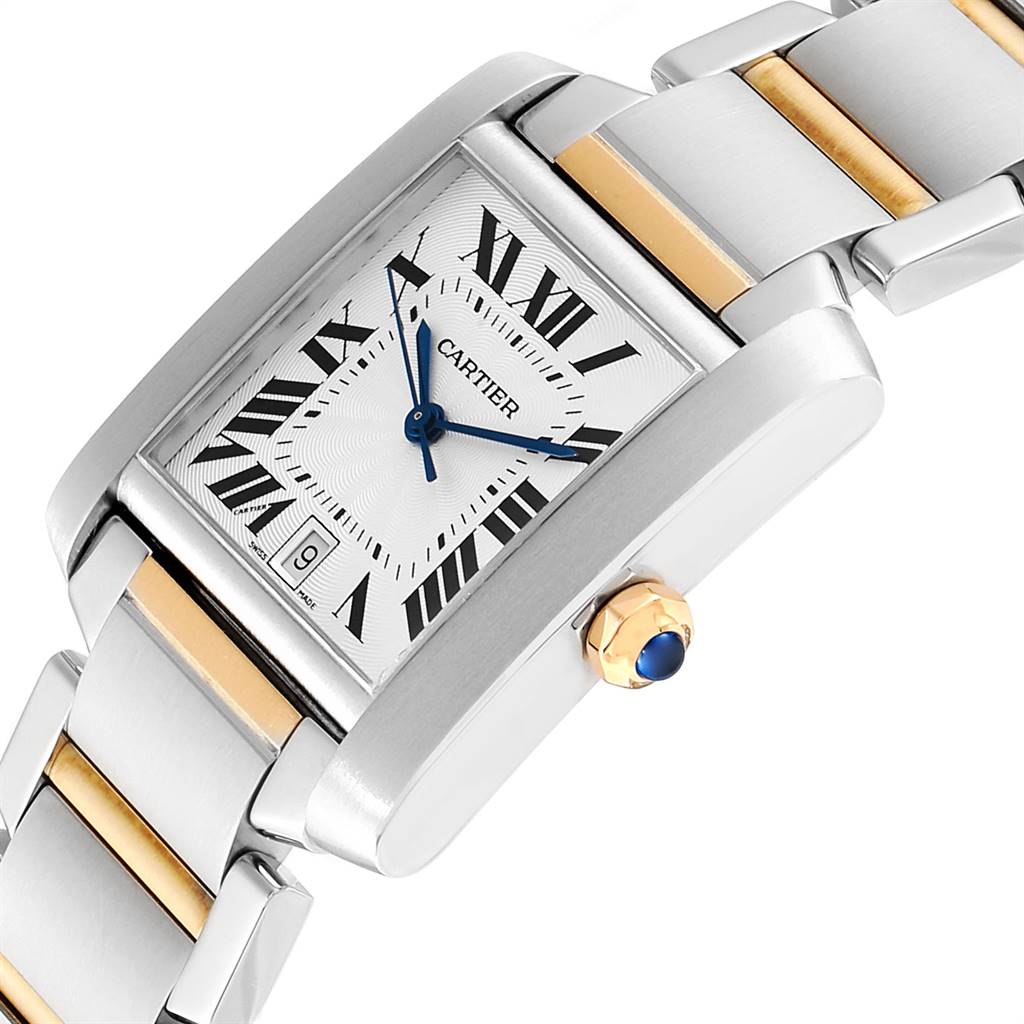 The image shows a close-up of a Cartier Tank Francaise W51005Q4 Men's Steel and Gold (two tone) Silver Dial W51005Q4 Men's Steel and Gold (two tone) Silver Dial watch, highlighting its rectangular face, bracelet, and crown with a blue gem.