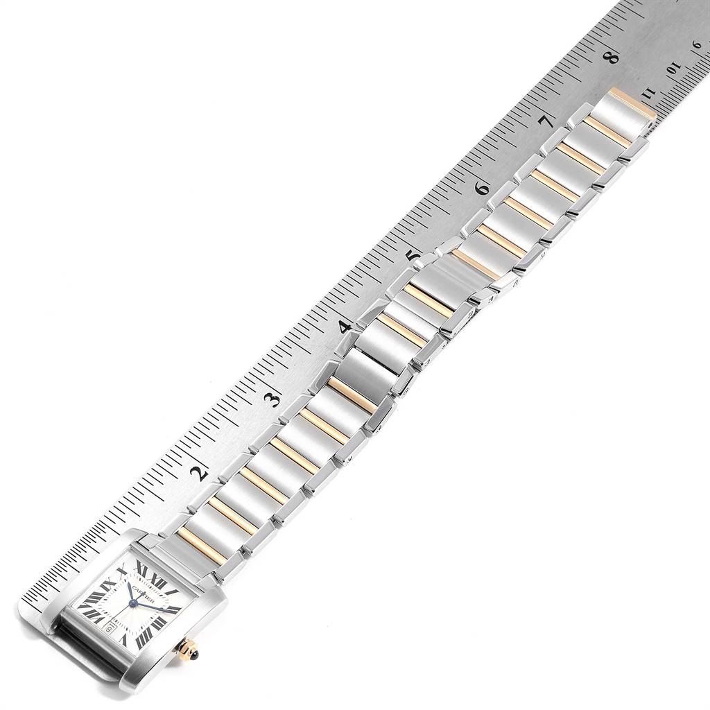 The Cartier Tank Francaise W51005Q4 Men's Steel and Gold (two tone) Silver Dial W51005Q4 Men's Steel and Gold (two tone) Silver Dial watch is displayed flat with a ruler, showing the timepiece and part of its metal band.
