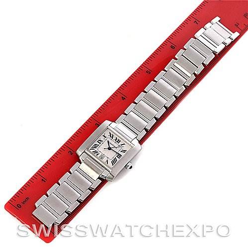 The image shows a top view of a Cartier Tank Francaise W51002Q3 Stainless Steel Silver Dial W51002Q3 Stainless Steel Silver Dial watch, laid flat on a red ruler, displaying its face and metal bracelet.
