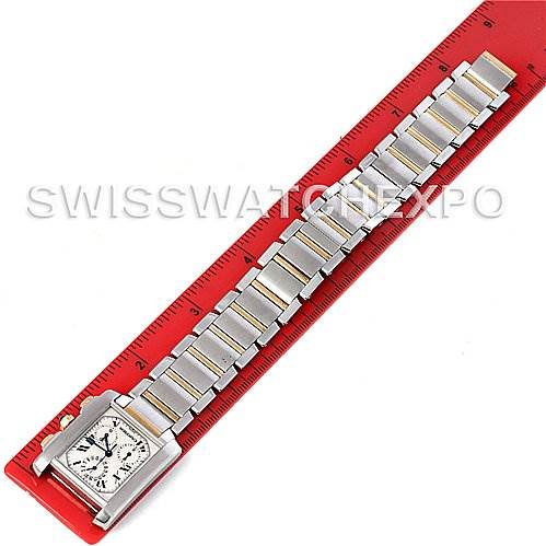 A Cartier Tank Française watch is shown laid flat from an overhead view, with its bracelet aligned alongside a red ruler.