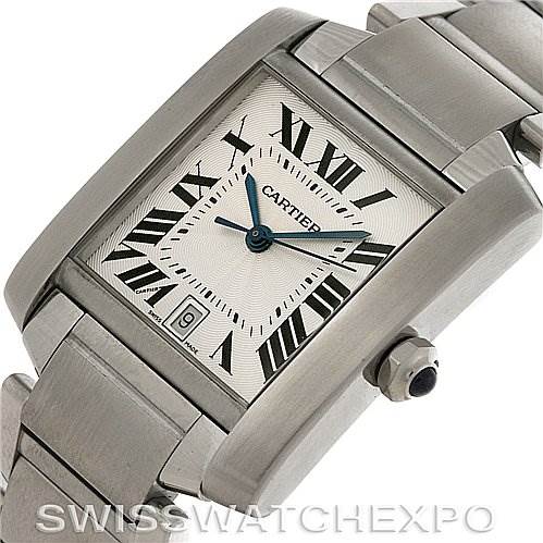 The image shows a close-up of a Cartier Tank Française watch, highlighting the dial, crown, and part of the bracelet.